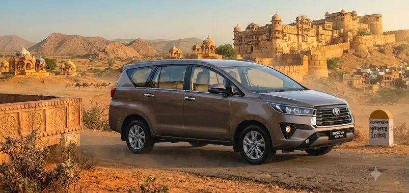 Modern touring vehicle driving past an ancient rajasthani fort and desert landscape