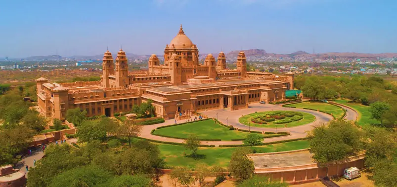 Majestic sandstone architecture and manicured gardens of Umaid Bhawan Palace in Jodhpur.